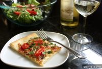 Sweet & Smoky Fontina Pizza with Bacon, Caramelized Onions, and Burst Tomatoes