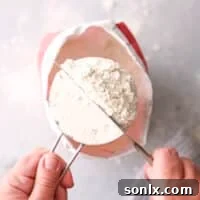 Illustrative image of sweeping a measurement of flour to ensure accuracy.