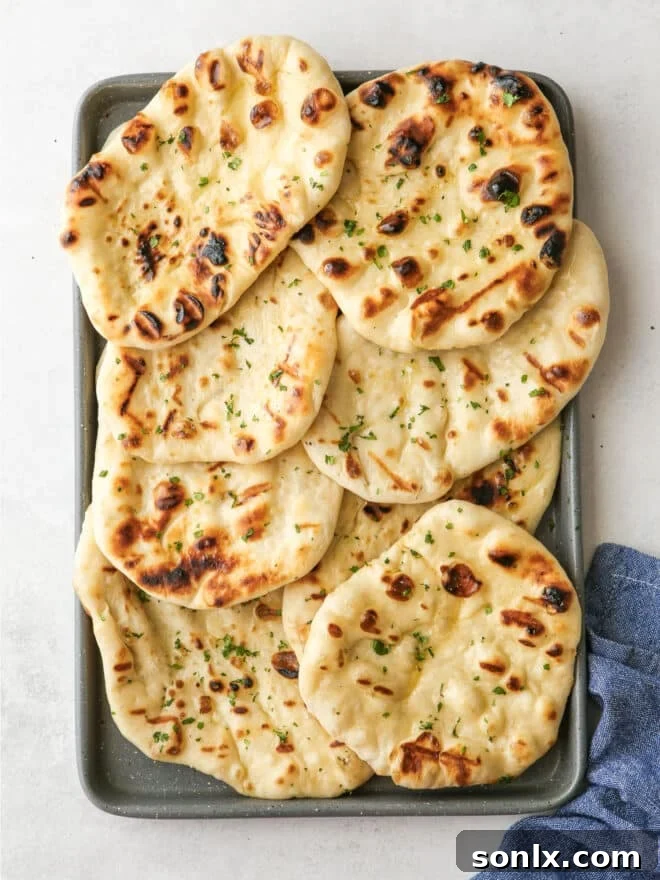 a freshly grilled flatbread cooling on a baking sheet pan, showcasing its golden color and slight char