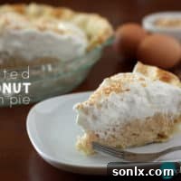 A perfectly baked Toasted Coconut Cream Pie, topped with whipped cream and golden toasted coconut flakes.