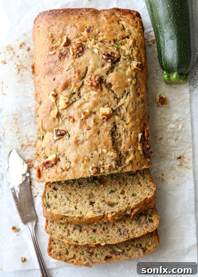 Moist and flavorful banana zucchini walnut bread, a perfect blend of two quick bread recipes, garnished with walnuts
