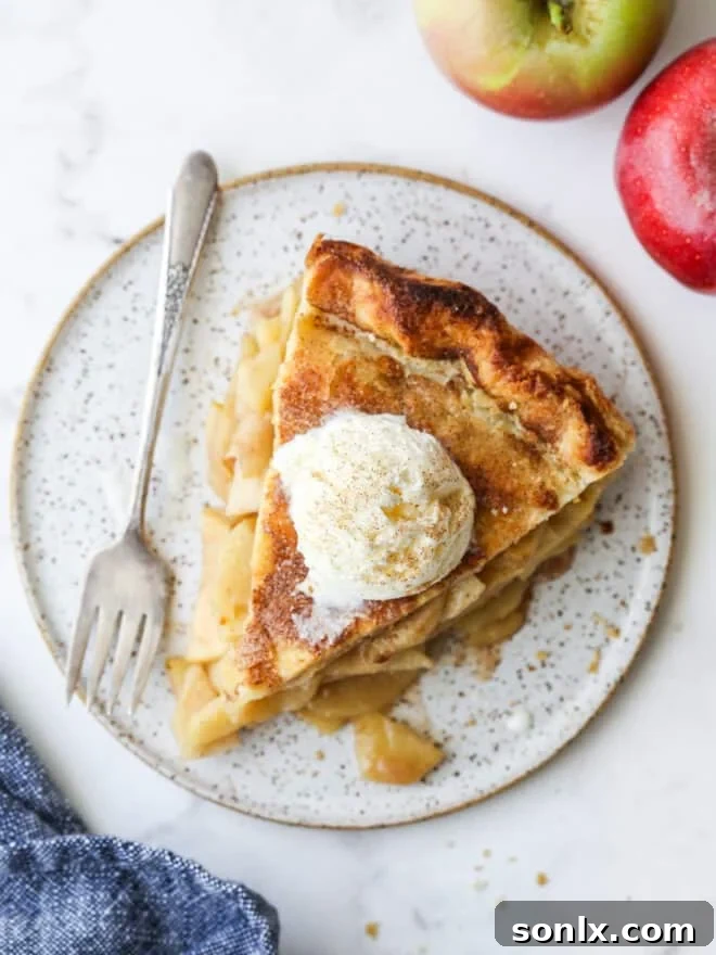 A beautifully baked deep dish apple pie, showcasing its impressive height.