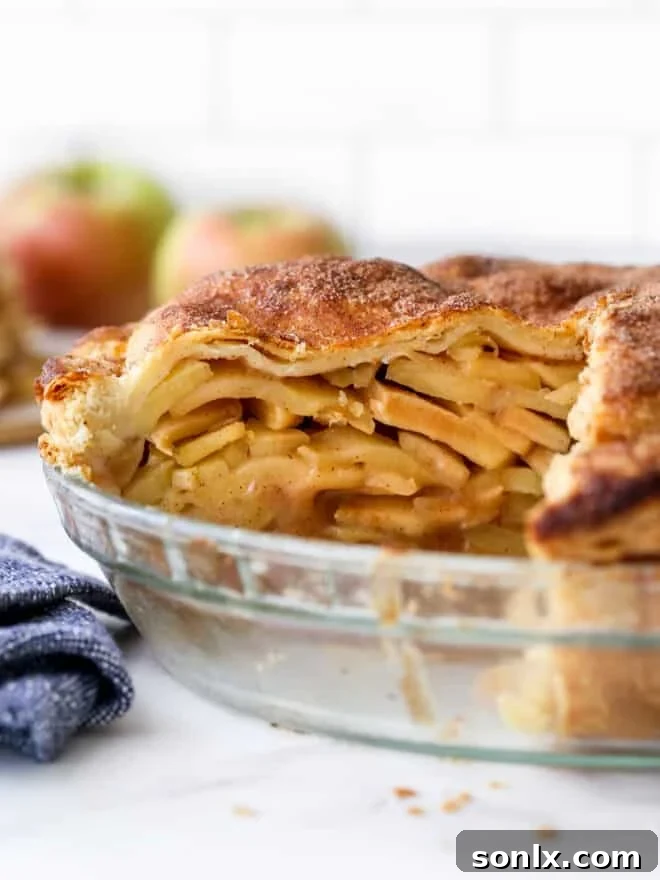 closeup of cut mile high apple pie in pan
