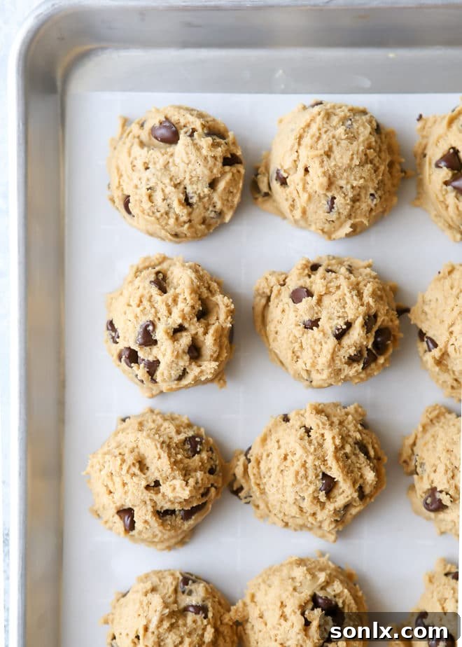 Scooped peanut butter chocolate chip cookie dough ready for baking