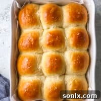 soft white dinner rolls in the baking pan