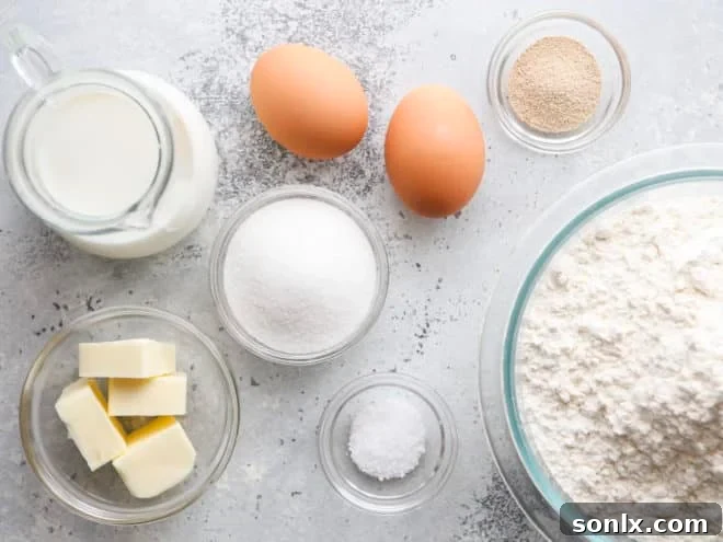 ingredients for making soft white dinner rolls laid out on a table