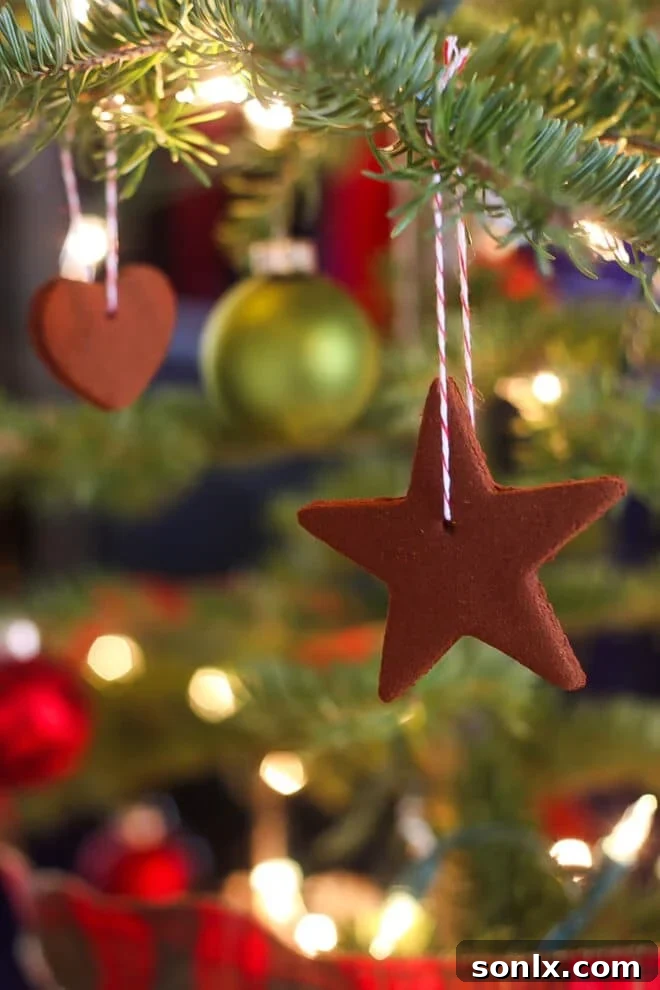 Homemade cinnamon ornaments hanging on a Christmas tree