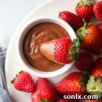 Chocolate Zabaglione (Chocolate Wine Sauce) in a small white bowl, garnished with chocolate shavings.