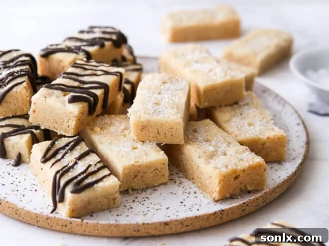 closeup of brown butter shortbread cookies on a plate, highlighting their crumbly texture