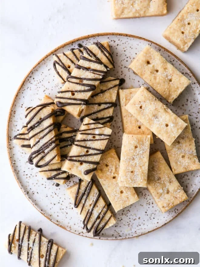 overhead view of brown butter shortbread cookies on a plate, showcasing varied toppings