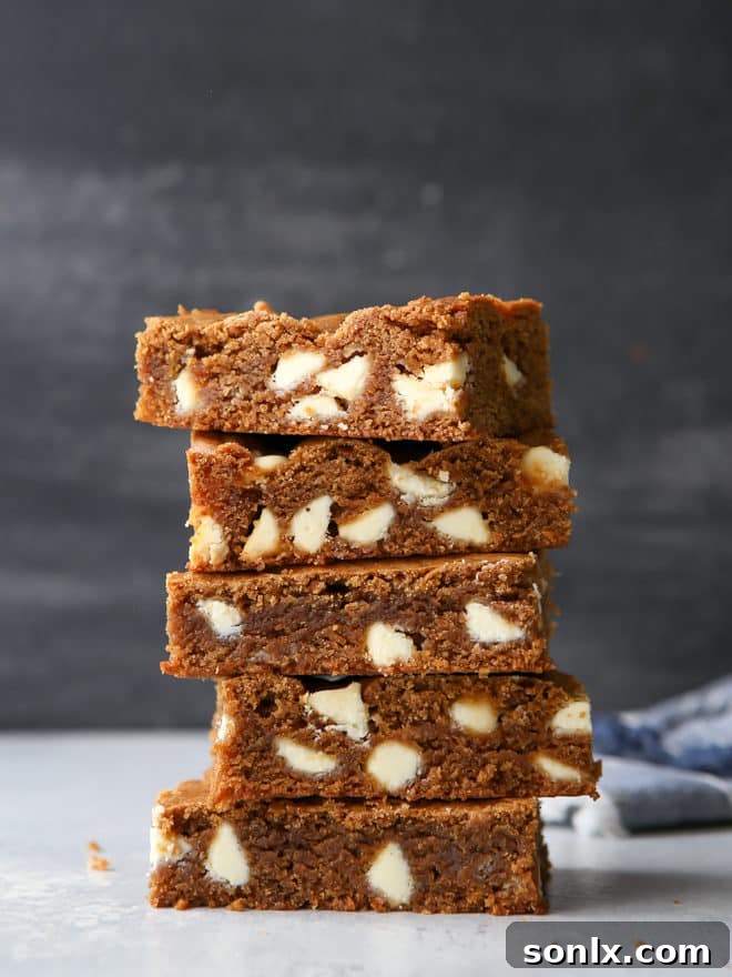 Soft gingerbread white chocolate blondies with molasses, white chocolate chips, and warm spices.
