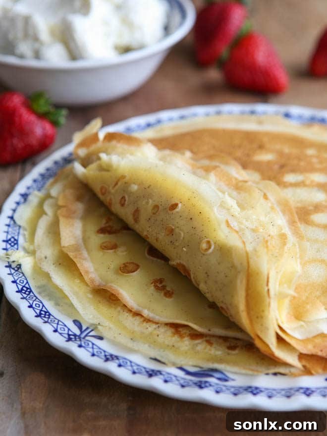 Homemade crepes ready to be served with strawberries and cream
