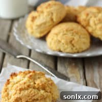 Freshly baked Maple Cornmeal Biscuits on a cooling rack.