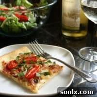 Freshly baked pizza with caramelized onions, bacon, cherry tomatoes, and fontina cheese.