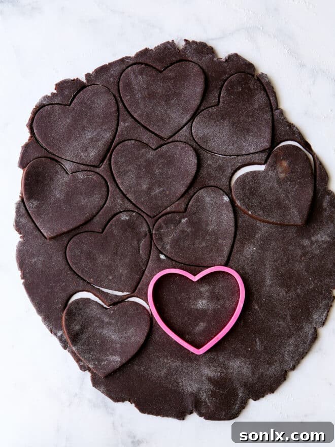 Unbaked chocolate sugar cookie cut-outs on a baking sheet