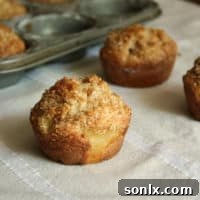 Freshly baked Pineapple Coconut Muffins with a crumb topping
