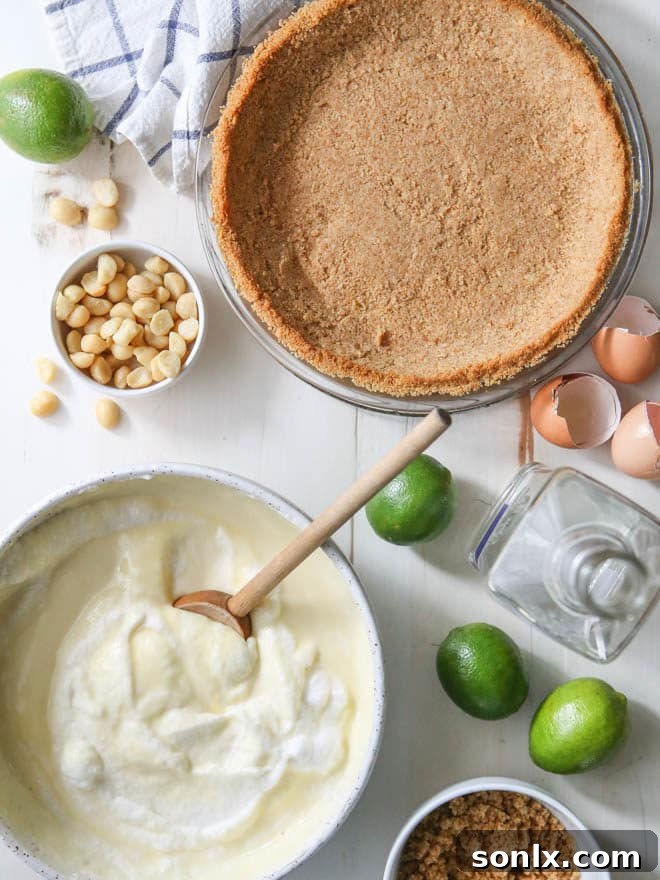 A Tequila Key Lime Pie being prepared before baking, showing the creamy green filling poured into the macadamia nut crust.