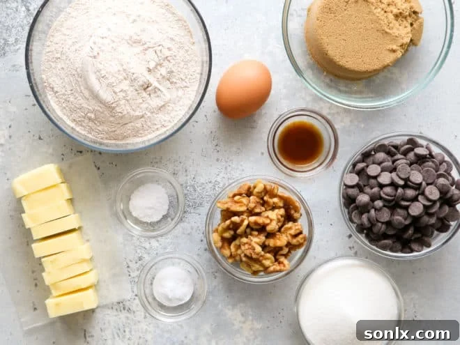 All the ingredients for whole wheat chocolate chip cookie bars spread out on a kitchen counter, ready for mixing.