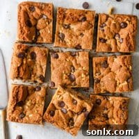 sliced whole wheat chocolate chip cookie bars with glass of milk