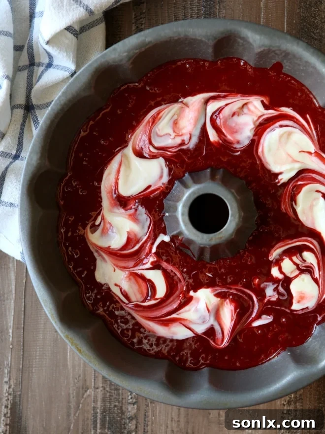 Close-up of the elegant Peppermint Red Velvet Bundt Cake with white chocolate drizzle