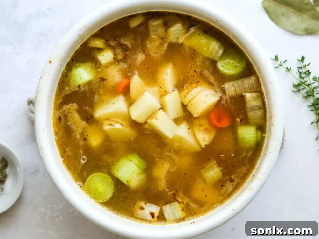 adding potatoes to soup