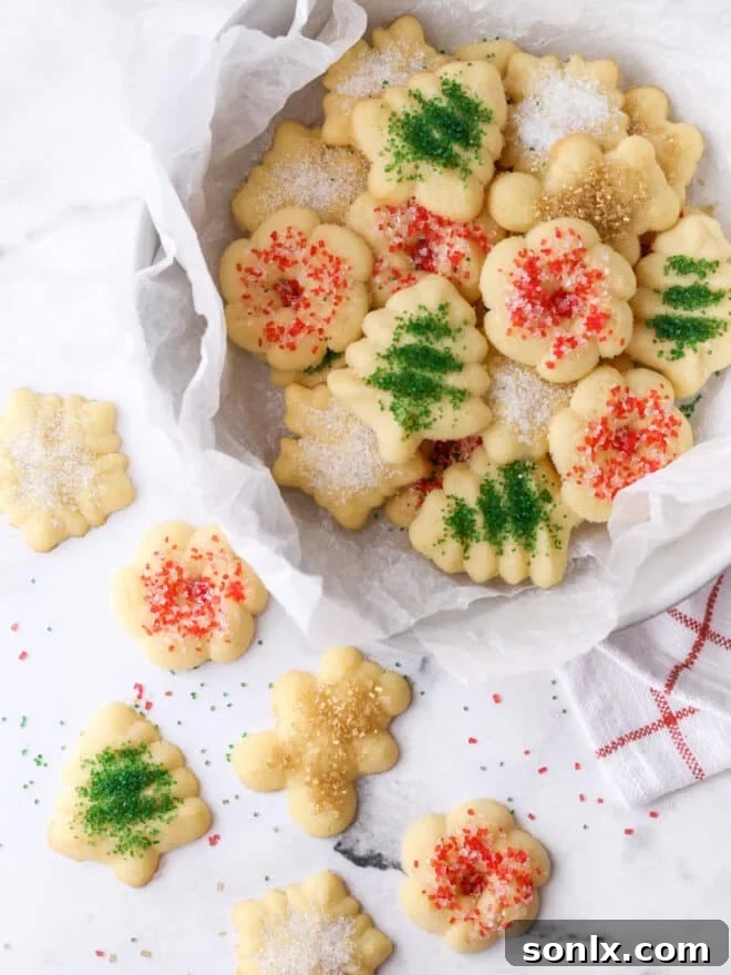A beautifully arranged display of spritz cookies, both in a bowl and on a table, showcasing their festive appeal.