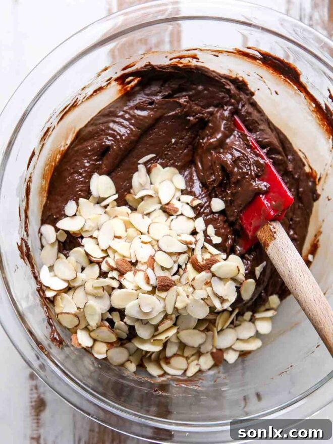 Close-up of melted chocolate being stirred in a bowl, a key step for the fudge base.