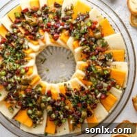 Marinated Cheese Appetizer with olives, red peppers, and herbs.