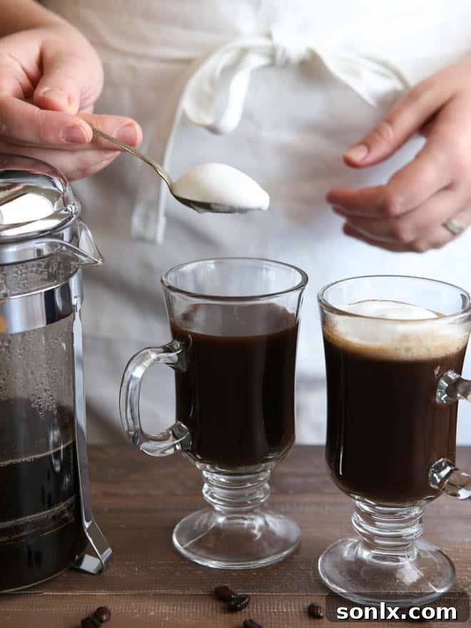 Topping the White Russian Mocha with creamy frothed milk, adding a luxurious touch.