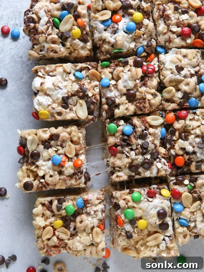 A hand reaching for a Monster Marshmallow Cereal Treat from a platter, emphasizing their grab-and-go appeal.