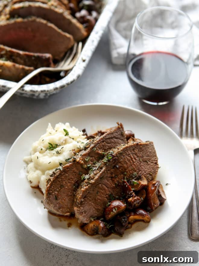 garlic and herb tri-tip roast with mushrooms on a plate