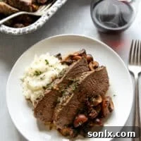 garlic and herb tri-tip roast with mushrooms on a plate