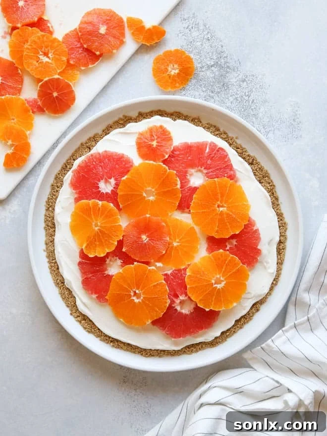A top-down view of the no-bake fruit pizza, showcasing the intricate arrangement of citrus slices.