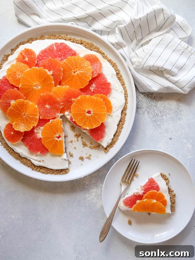 A prepared no-bake fruit pizza with a generous topping of fresh citrus, ready to be served.