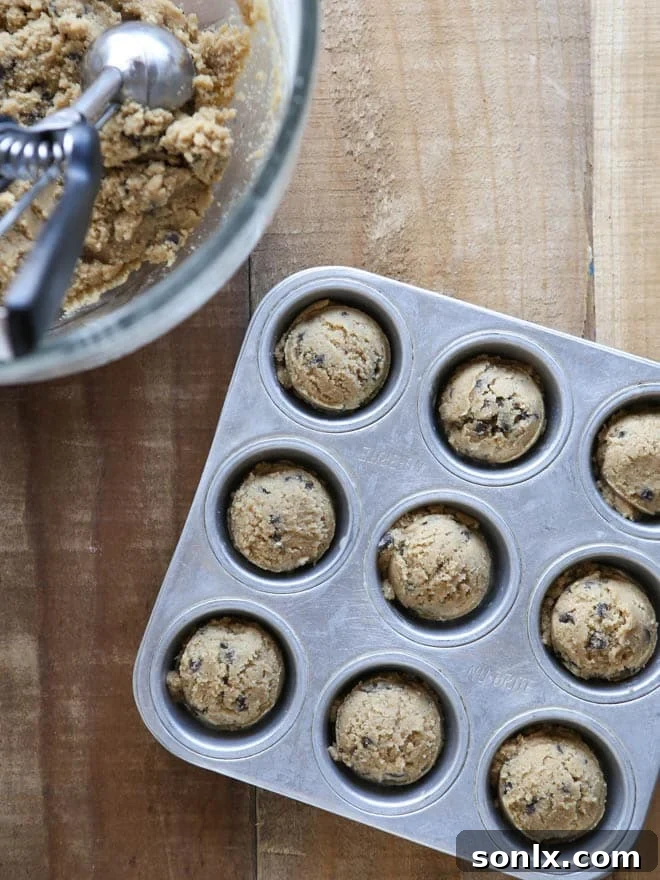 Close-up shot of Chocolate Chip Cookie Cups, baked golden brown and ready to be filled with creamy frosting. The ideal base for a delightful dessert.