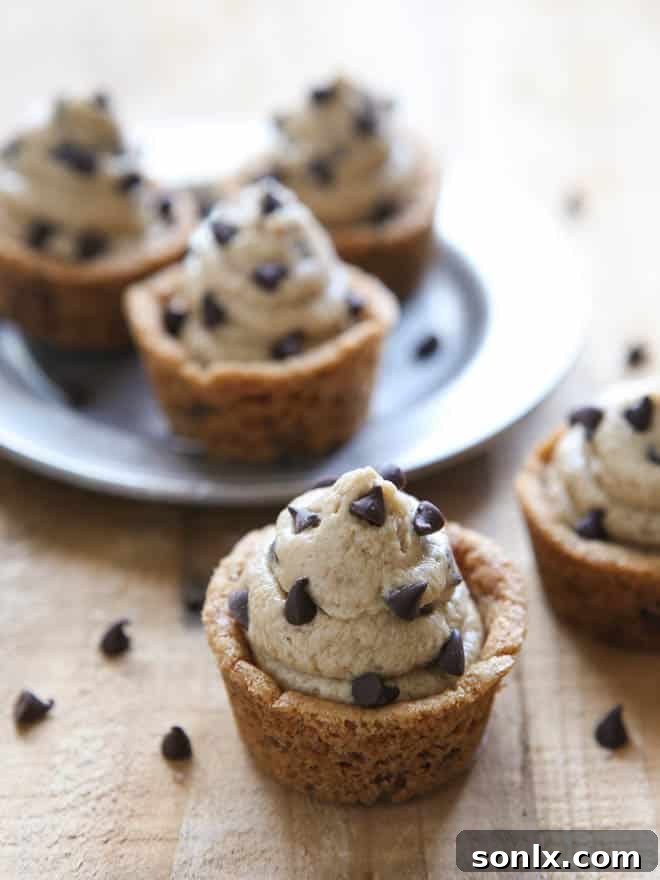 Beautifully arranged Chocolate Chip Cookie Cups with Cookie Dough Frosting, ready to be served and enjoyed at any gathering or special occasion.