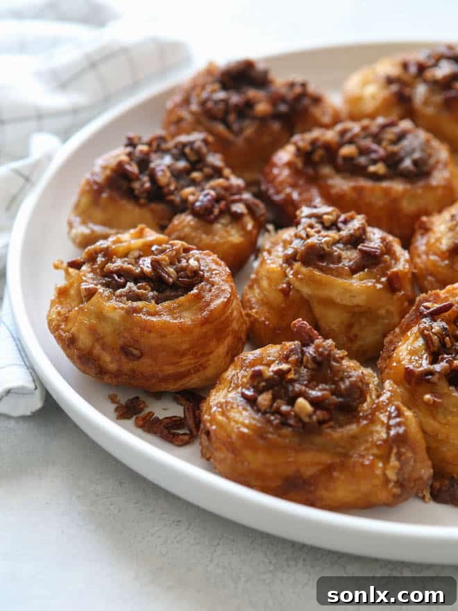 A plate of Easy Puff Pastry Sticky Buns with melted caramel and pecans