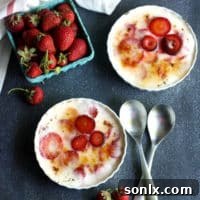A close-up view of Strawberry-Yogurt Brulée in a ramekin, showcasing the perfectly caramelized sugar crust and fresh strawberries beneath.