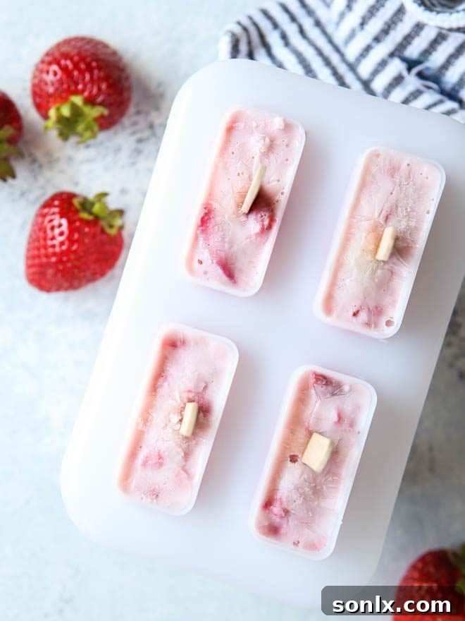 Roasted strawberry yogurt pops heading to the freezer