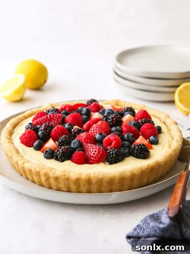 Lemon berry tart with a flaky crust and fresh berries on top