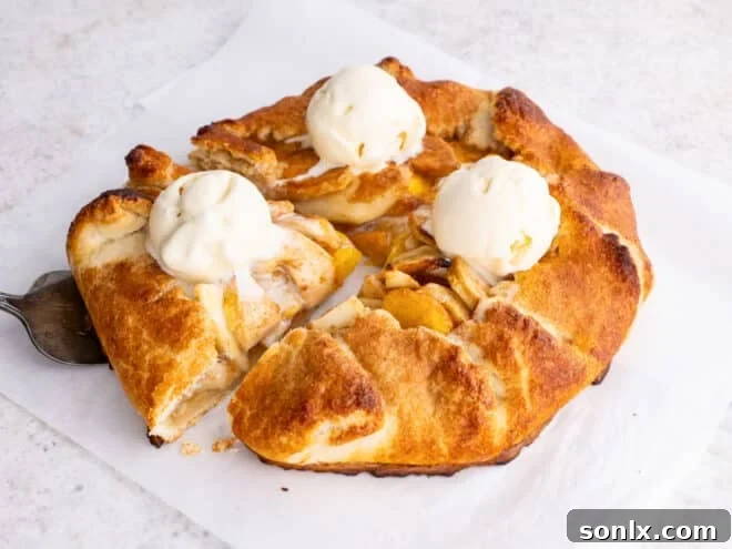 Rustic Orchard Peach Apple Galette 3 Freshly baked peach apple galette adorned with scoops of melting vanilla ice cream, ready to be served
