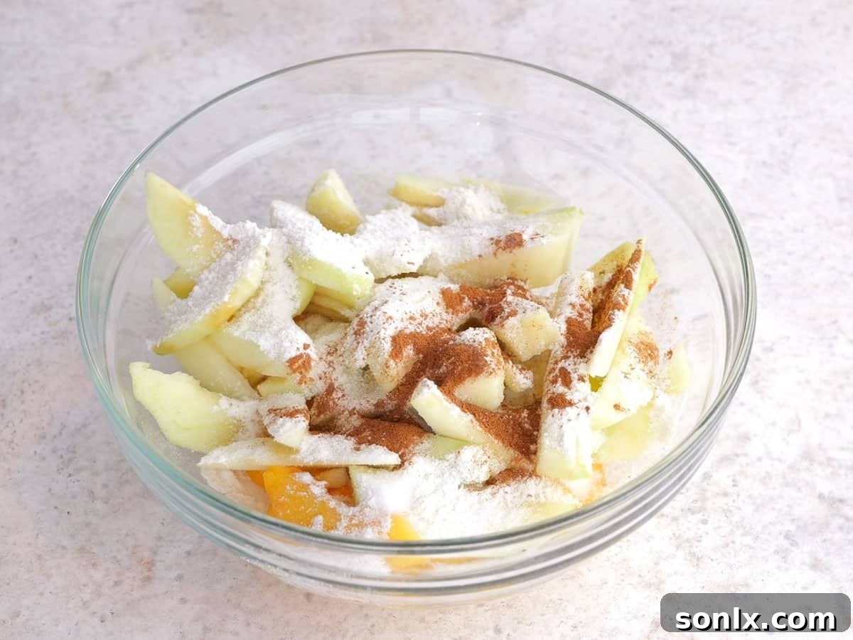 Rustic Orchard Peach Apple Galette 6 Bowl of sliced peaches and apples tossed with sugar, flour, and cinnamon, ready for galette filling