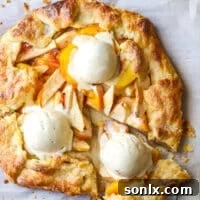 Deliciously sliced peach apple galette with melting ice cream on top