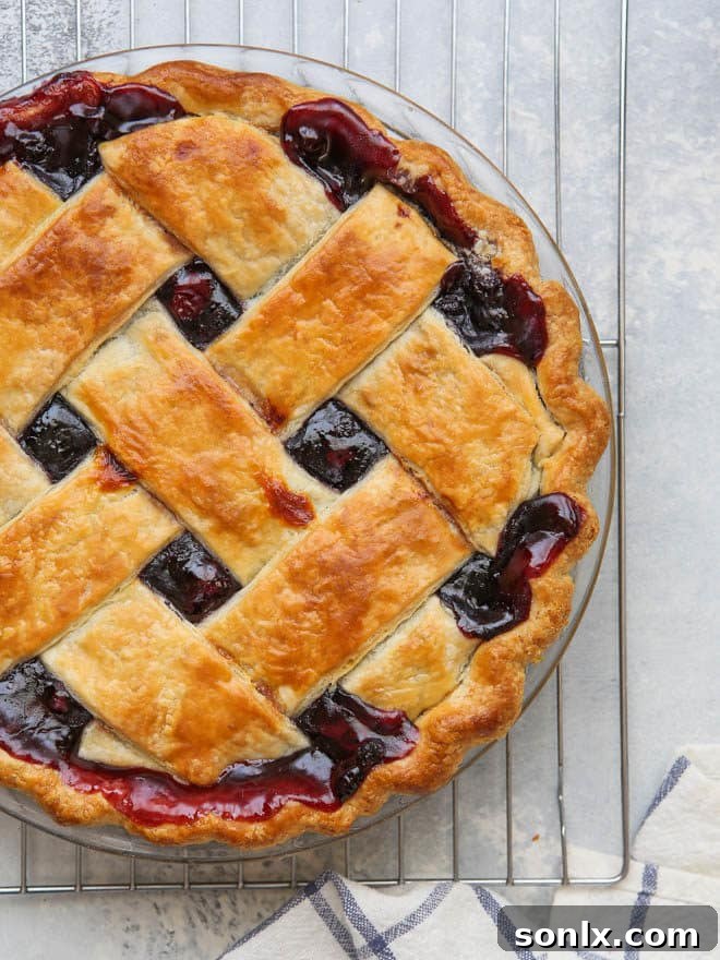 A pie with its edges covered by a foil shield to prevent over-browning.