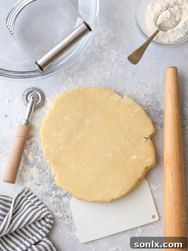 A comprehensive collection of essential pie baking tools, including rolling pins, pastry blenders, and pie dishes, neatly arranged on a rustic wooden surface.