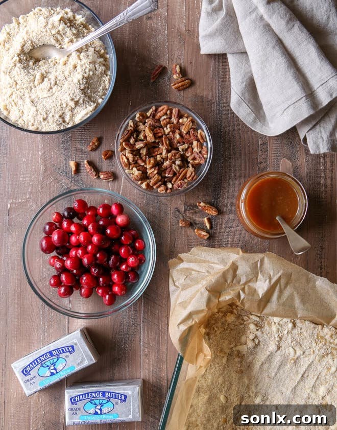 All the premium ingredients laid out for making caramel cranberry pecan nut bars at home.