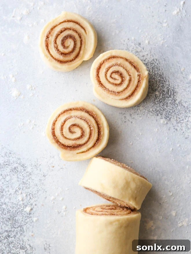 Close-up of a single cinnamon roll, showing the soft, gooey interior and frosting.
