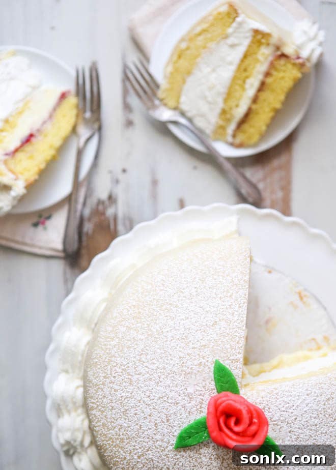Elegant Princess Cake featuring sponge cake, vanilla custard, raspberry jam, and marzipan