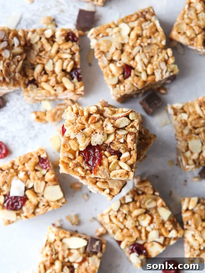 No-bake cereal bars with dried cherries, almonds, and coconut arranged on a plate