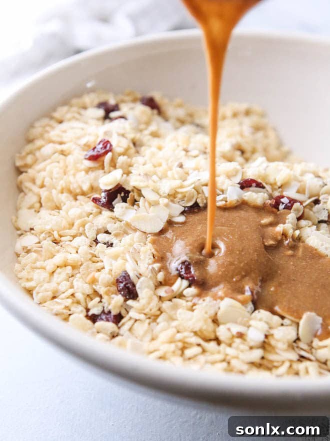 Stacked healthy no-bake cereal bars with dried cherries, almonds, and coconut